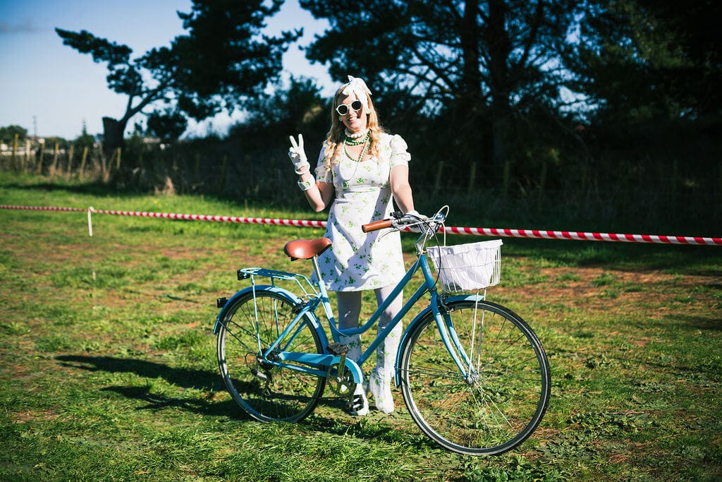 A person in costume with a retro bike